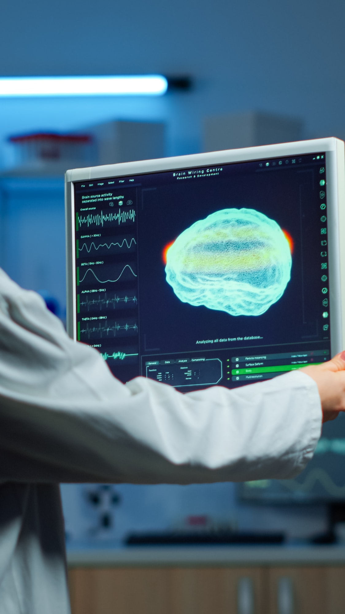 Neurologist doctor looking at monitor examining brain scan
